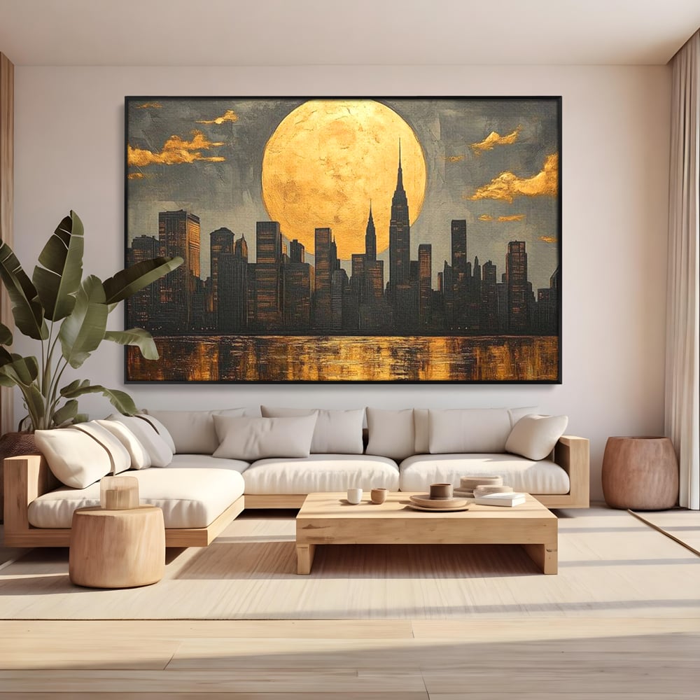 Tablou canvas cu pictura orizontala cu metropola si luna aurie, in rama de aluminiu negru, pe perete intr-un living